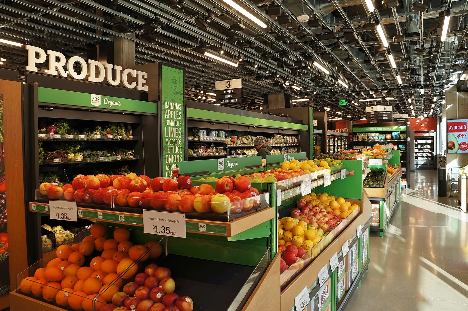 Produce displays beneath ceiling-mounted cameras and sensors in an Amazon Go Grocery store.