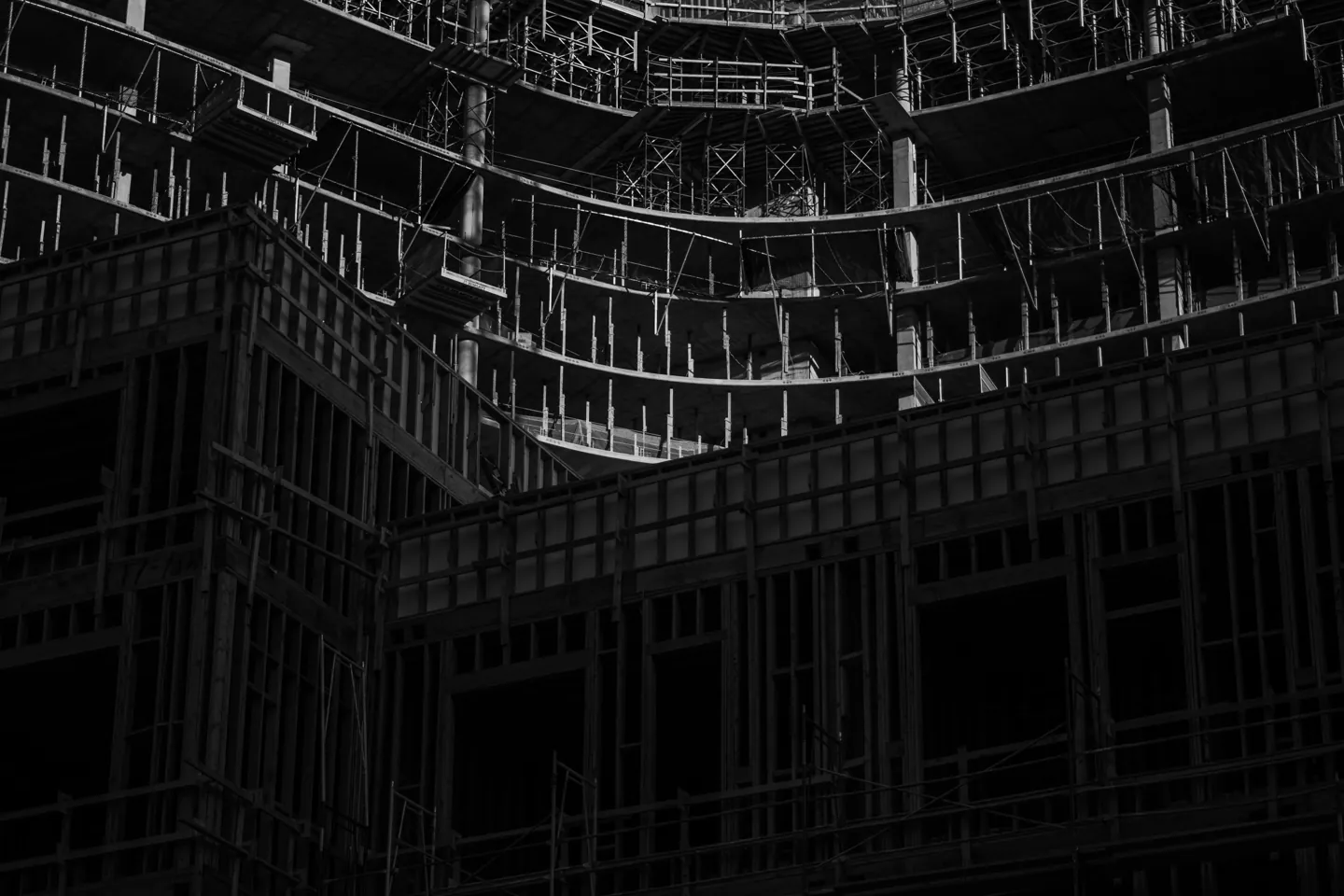 Scaffolding and exposed floors at a construction site in Koreatown, Los Angeles, photographed in black and white.