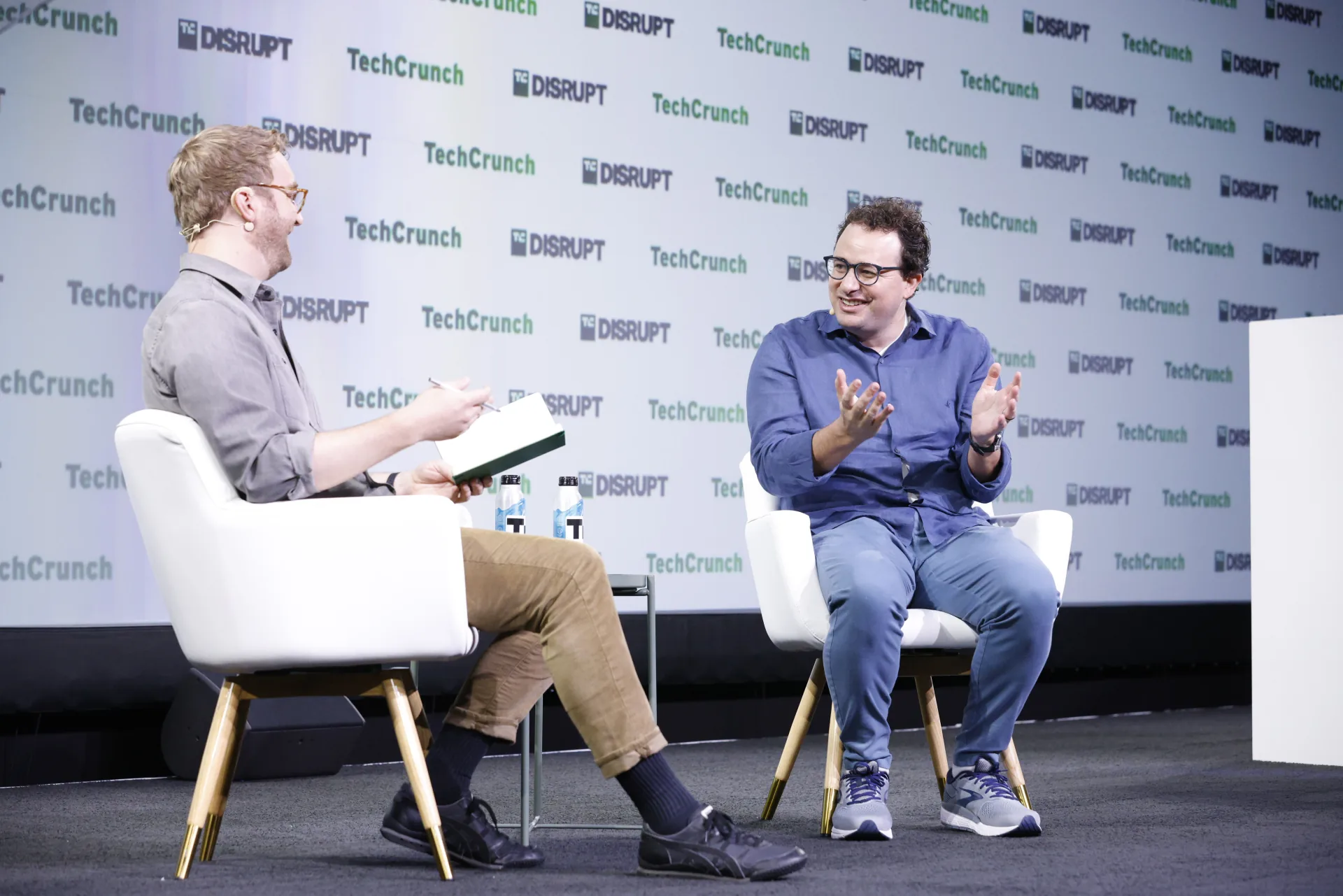 Dario Amodei, right, gestures while seated across from Devin Coldewey on the TechCrunch Disrupt stage.