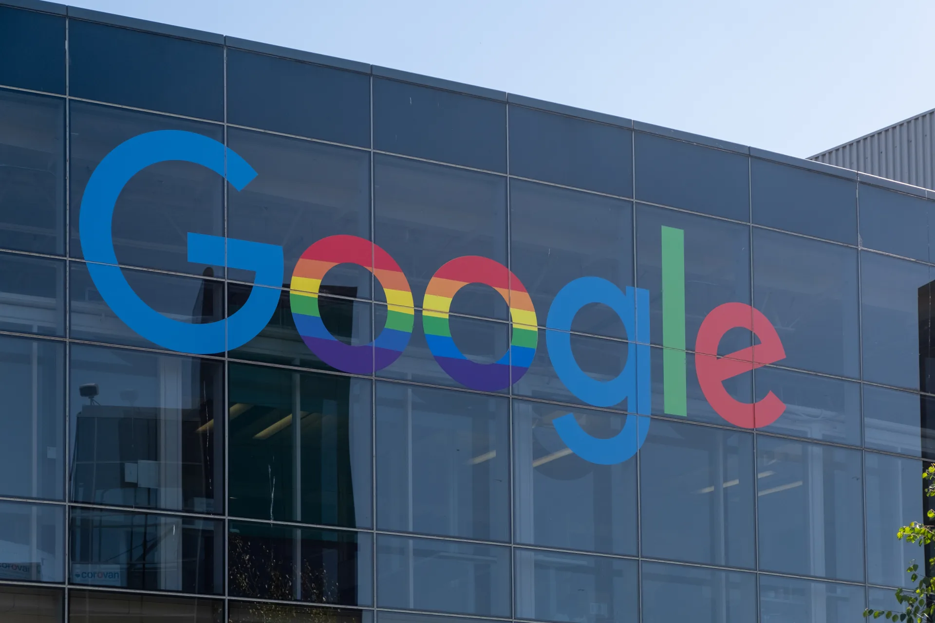 A large Google logo on the glass facade of a building at the Googleplex in Mountain View.