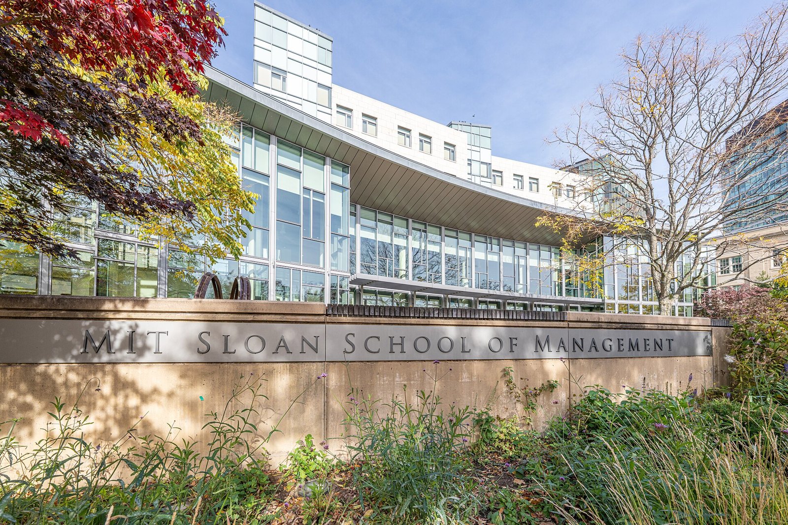 The MIT Sloan School of Management building and campus sign in Cambridge, Massachusetts