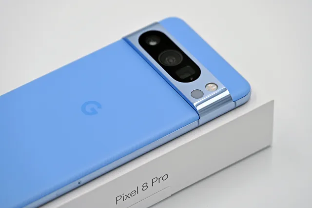 A blue Google Pixel 8 Pro smartphone resting on its retail box.