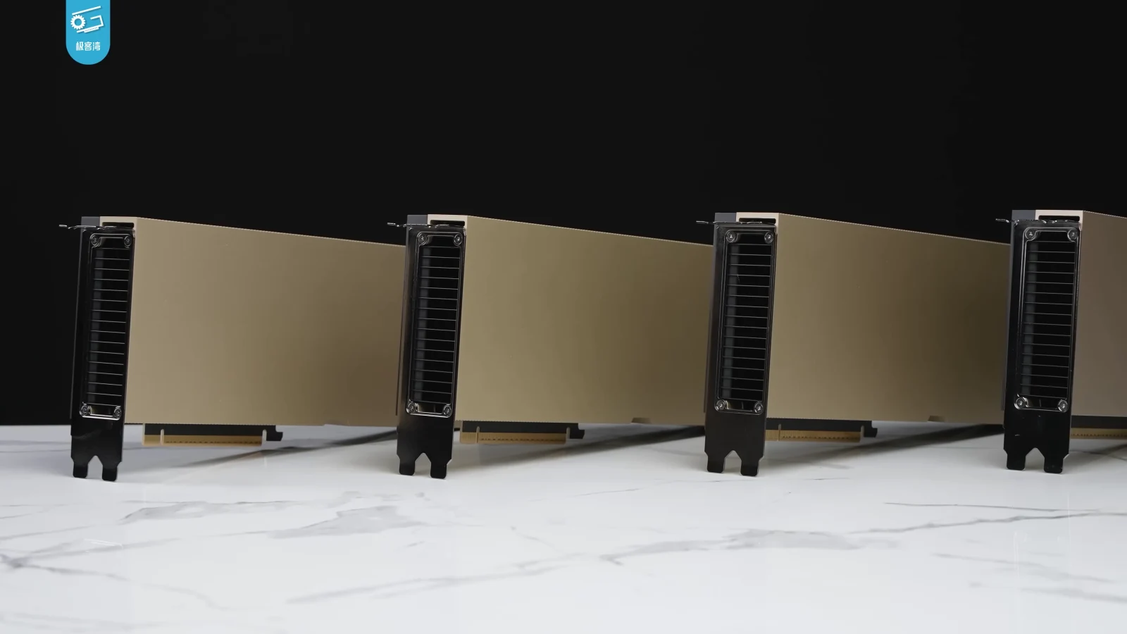 Four NVIDIA H100 graphics cards arranged on a dark tabletop