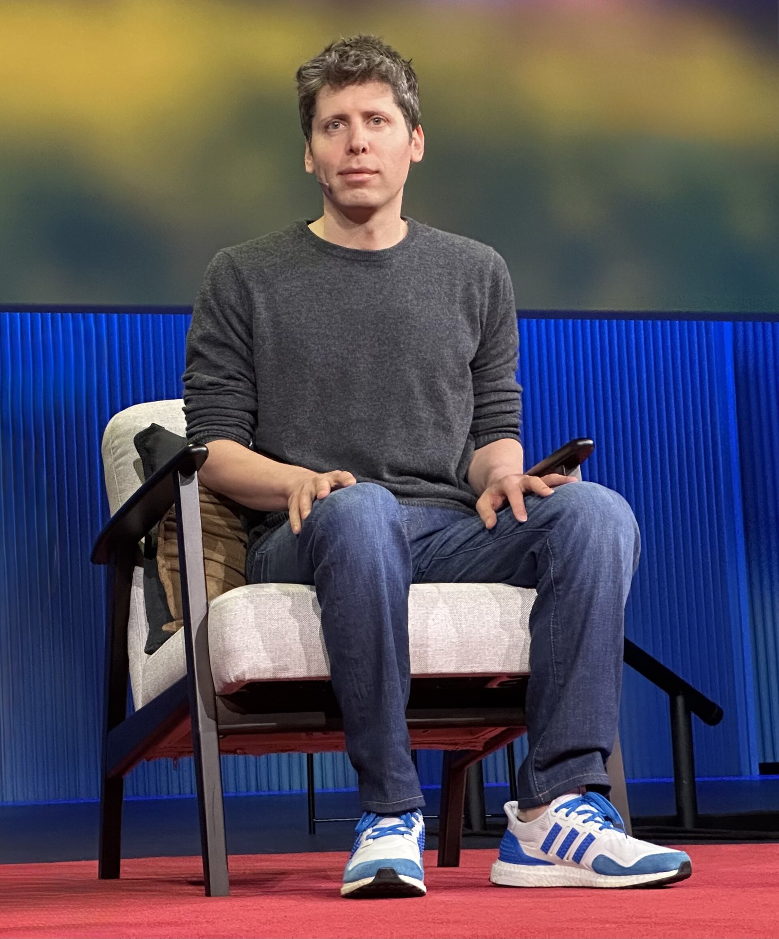 Sam Altman seated on stage at TED in Vancouver