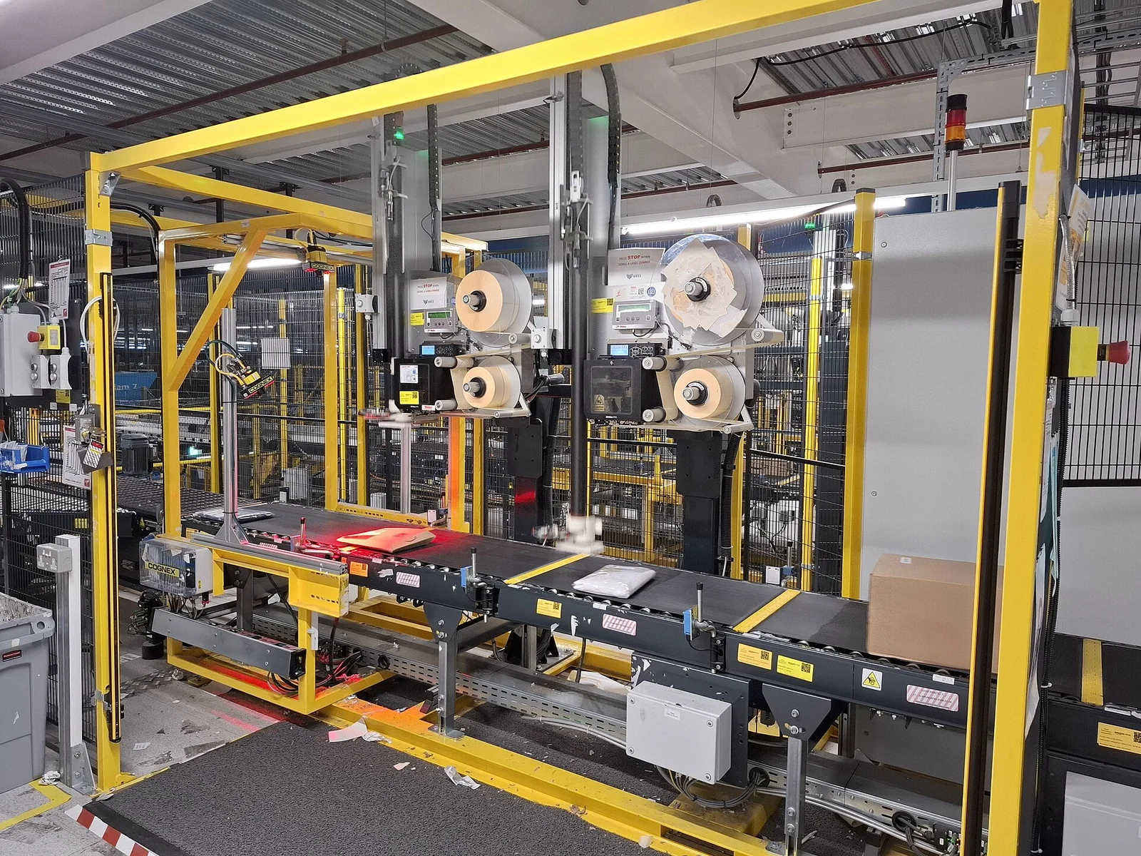 Conveyor belts pass through scanning and labeling machinery at Amazon’s Swindon fulfillment center.