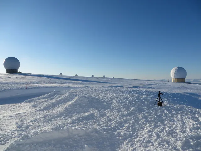 White antenna domes on the snow-covered plateau at Svalbard Satellite Station.