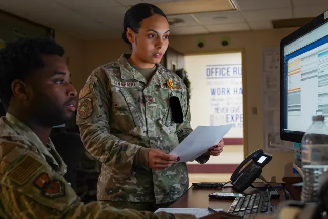 Destani Alvarado and Michael Wallace review a medical record on a computer at Keesler’s medical center.