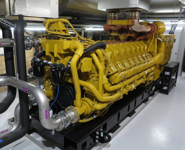 A large yellow Caterpillar emergency generator at the Frasnacht waterworks