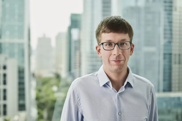 Databricks cofounder Matei Zaharia standing beside a window