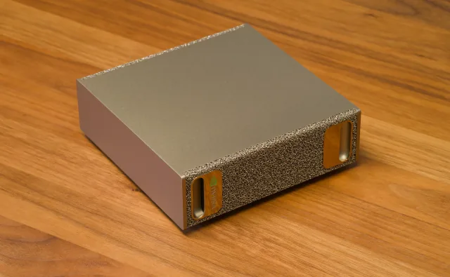 NVIDIA DGX Spark desktop AI computer photographed on a wooden desk